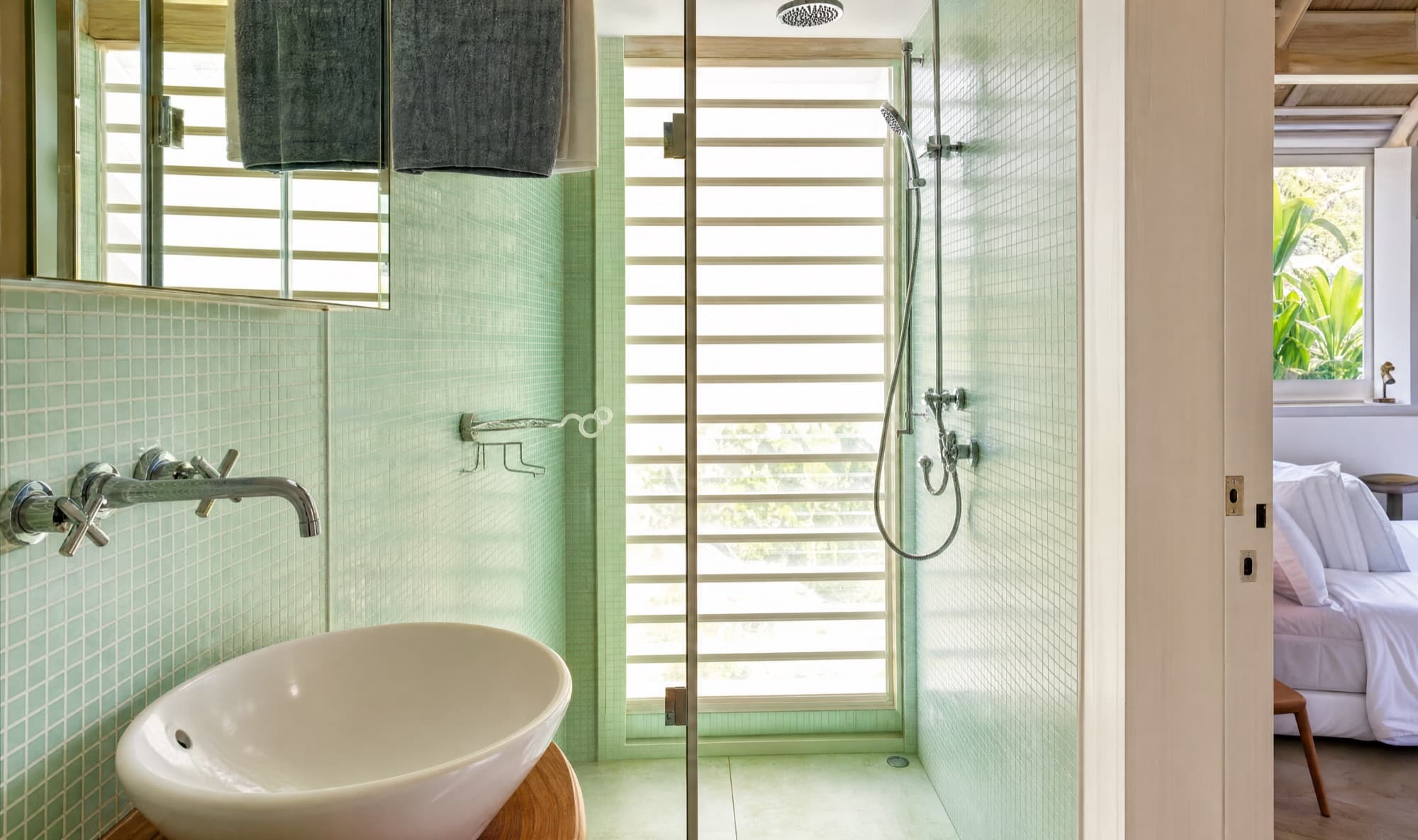 Sea-green mosaic walk-in shower with rain head and louvred light