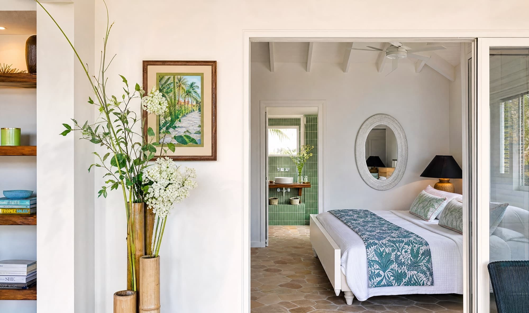 Looking into the bedroom suite past bamboo vases, with the spa bathroom beyond