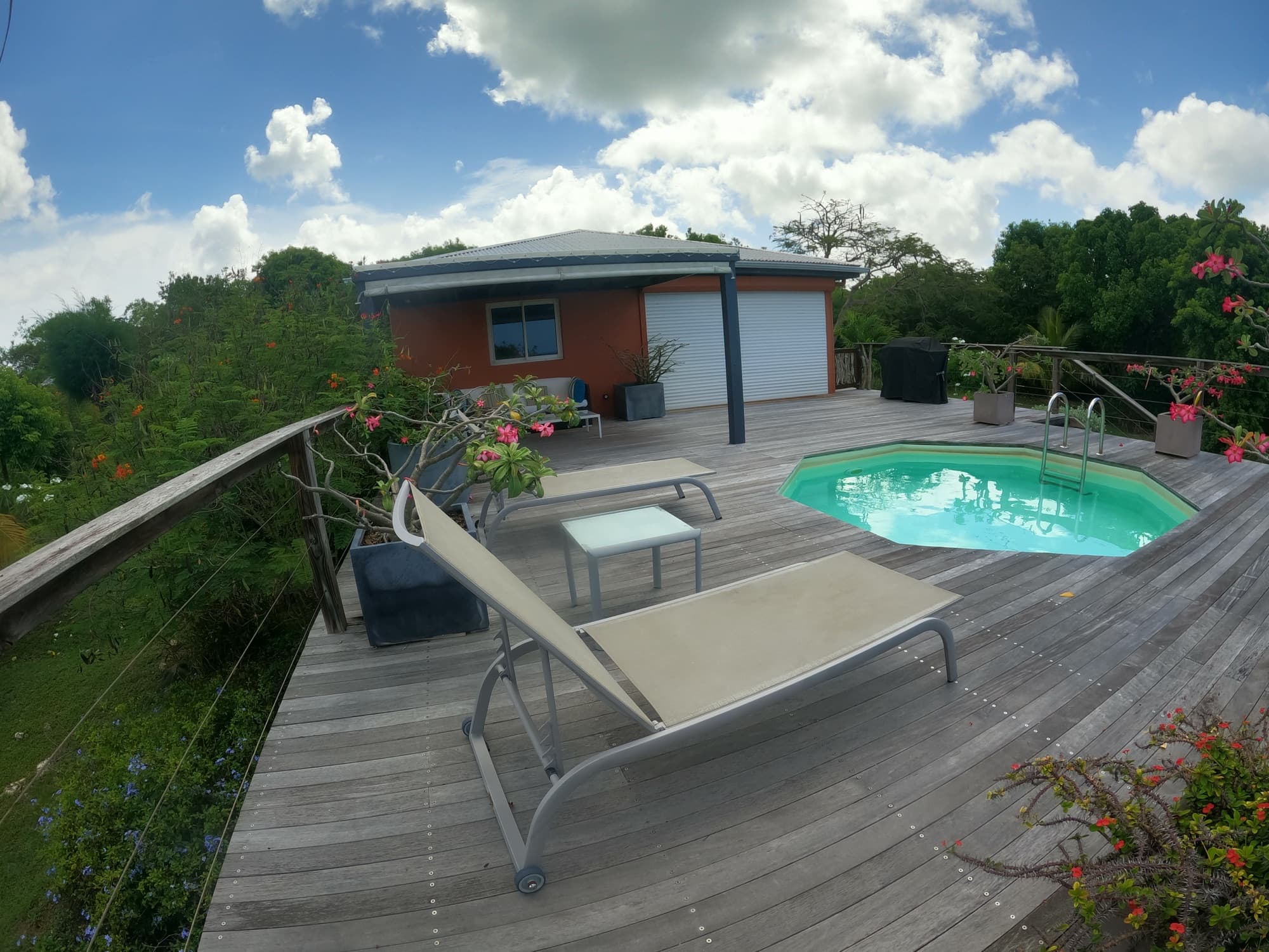 The coral-toned villa beside its plunge pool and sun loungers on the deck