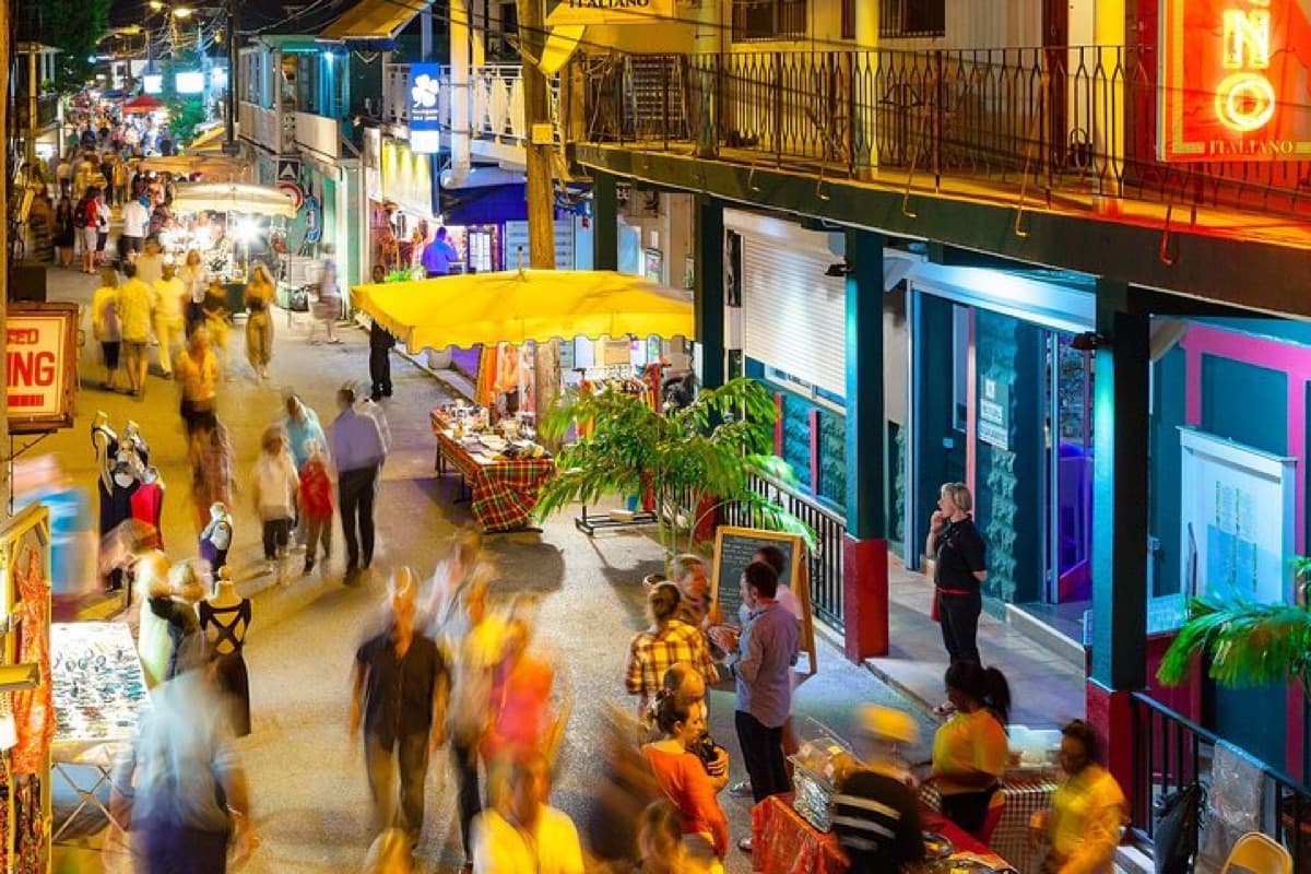 Restaurants and market stalls on the main street of Grand Case in the evening